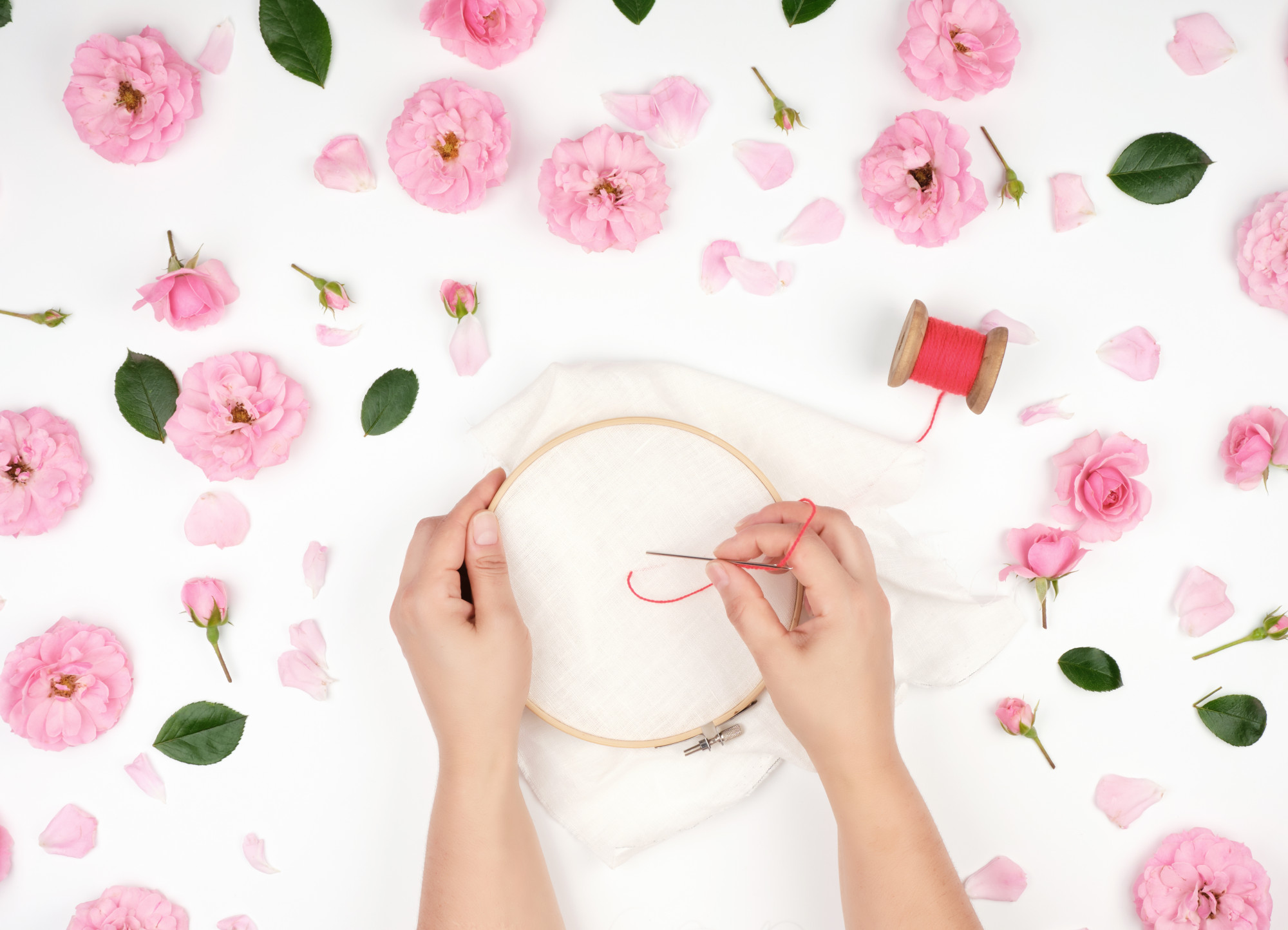 Student stitching floral pattern during class